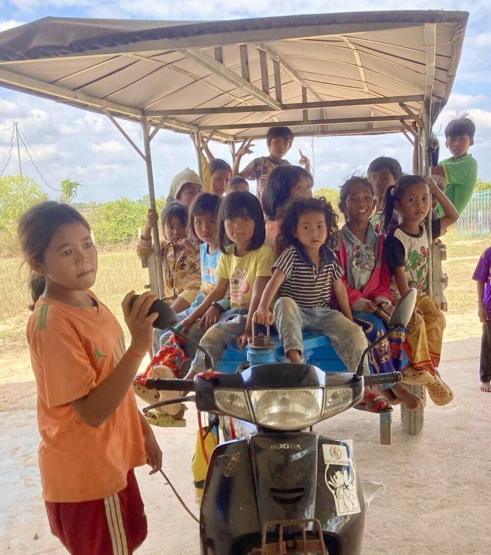 Children boarding a bus on the way to a Light of Cambodia gathering