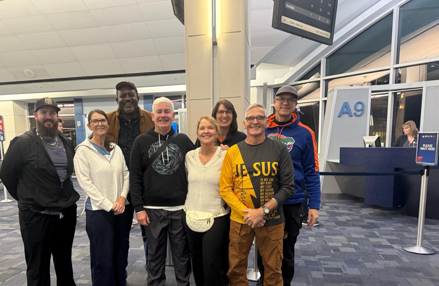 The traveling team together at the airport gate before departure