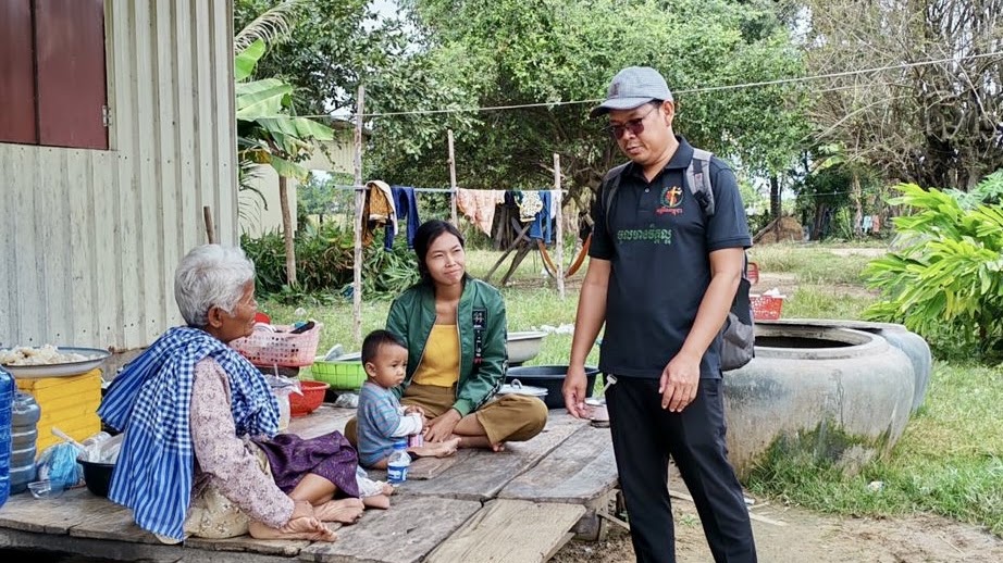 A ministry worker visiting an elderly woman and her grandchildren at their home