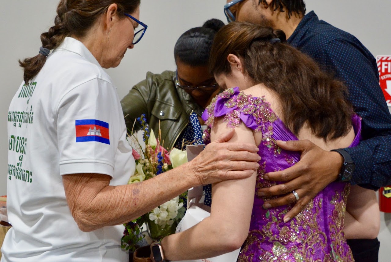 Team members embracing in prayer