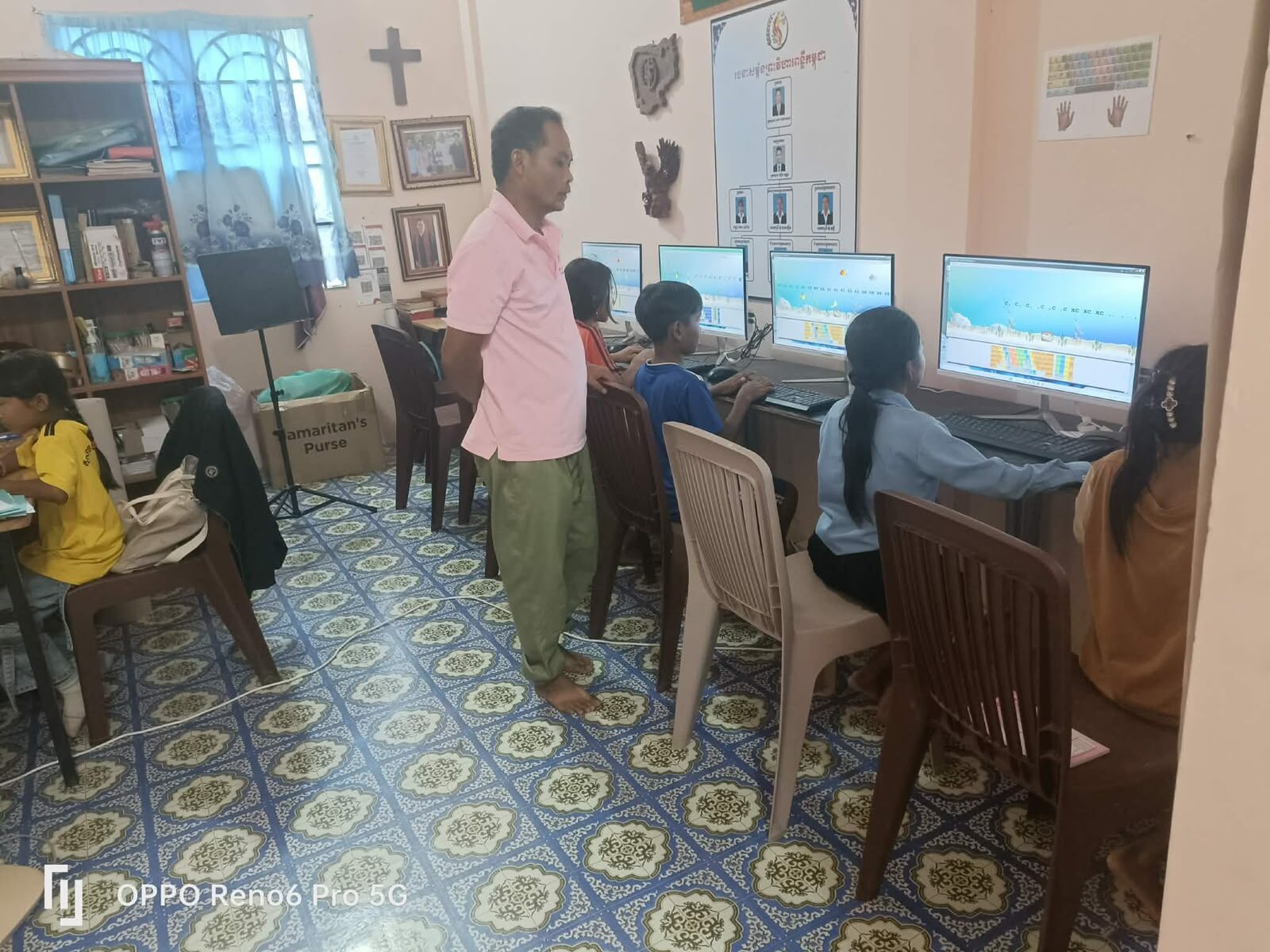 Children seated at desktop computers during class in Pursat